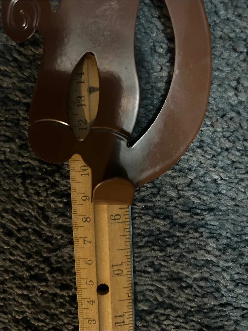 A set of 3 whimsical brown metal monkey over-the-door hooks